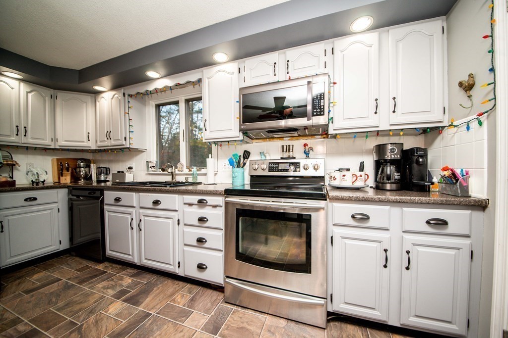 16 Gammons Road Acushnet, MA 02743 - Photo 21 of 31 a kitchen with stainless steel appliances granite countertop white cabinets a sink and dishwasher