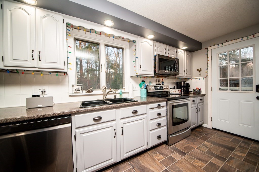 16 Gammons Road Acushnet, MA 02743 - Photo 24 of 31 a kitchen with stainless steel appliances granite countertop a sink a stove and a microwave