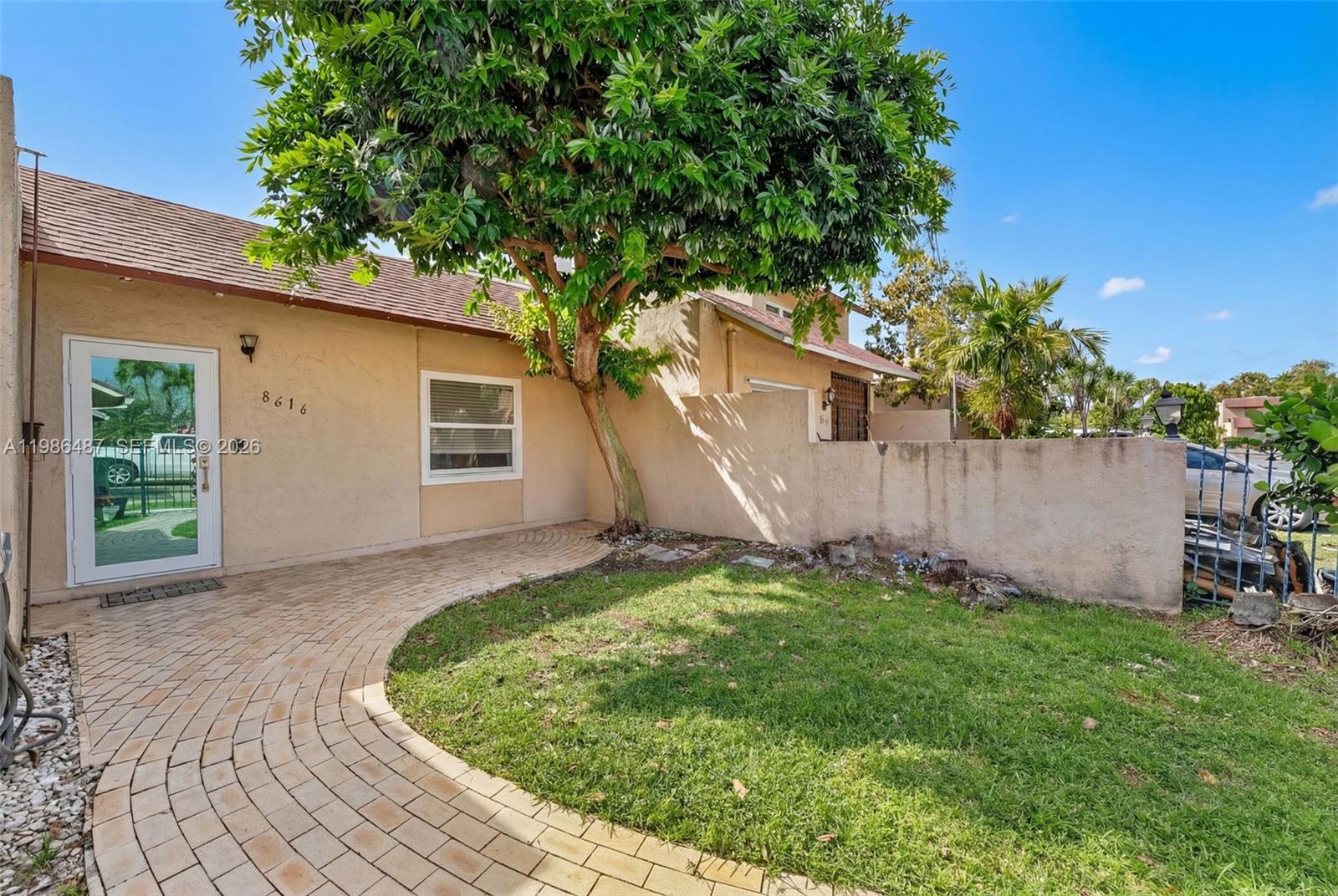8616 Southwest 103rd Avenue Miami, FL 33173 - Photo 1 of 20 a backyard of a house with plants and a tree
