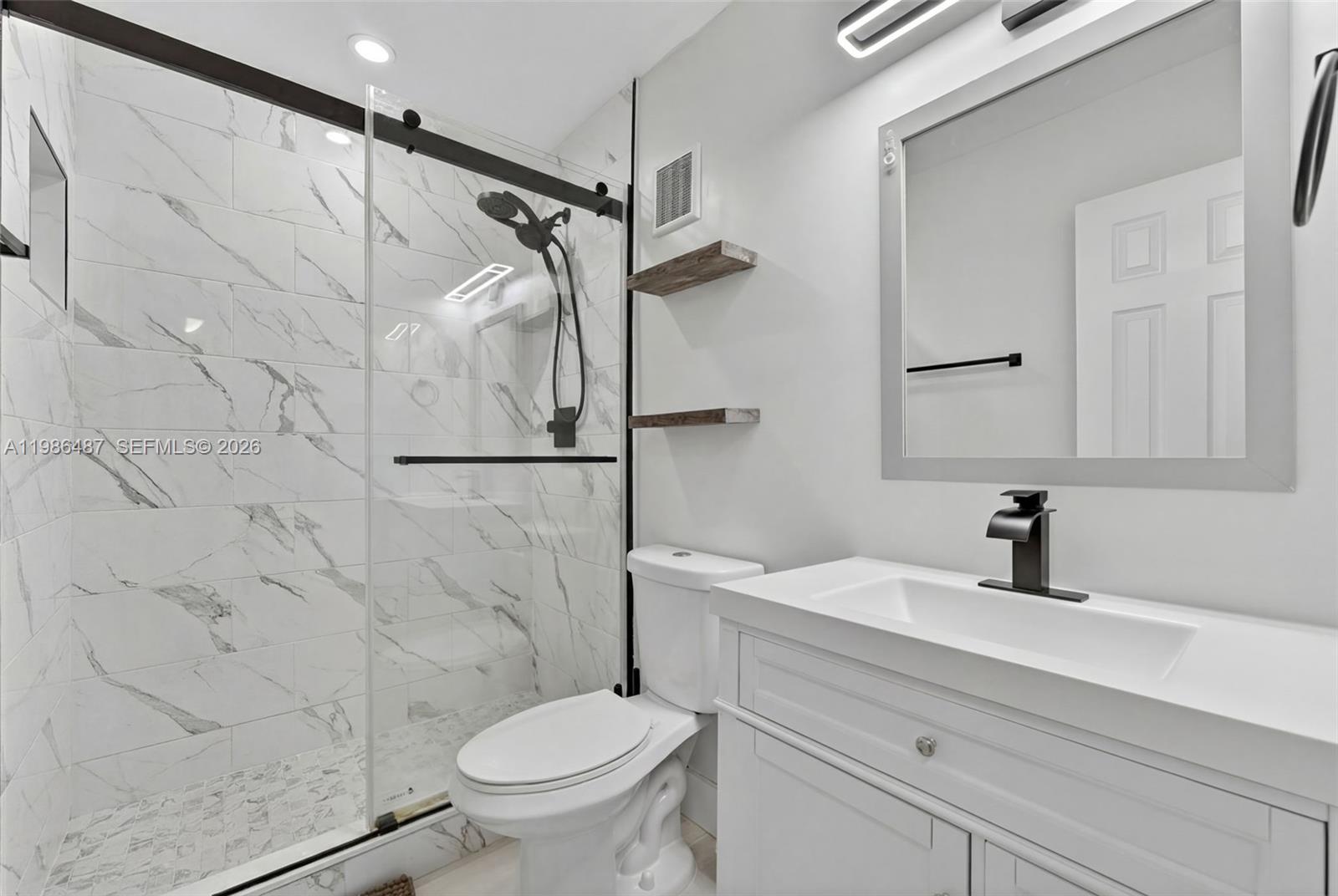 8616 Southwest 103rd Avenue Miami, FL 33173 - Photo 12 of 20 a bathroom with a sink toilet and shower