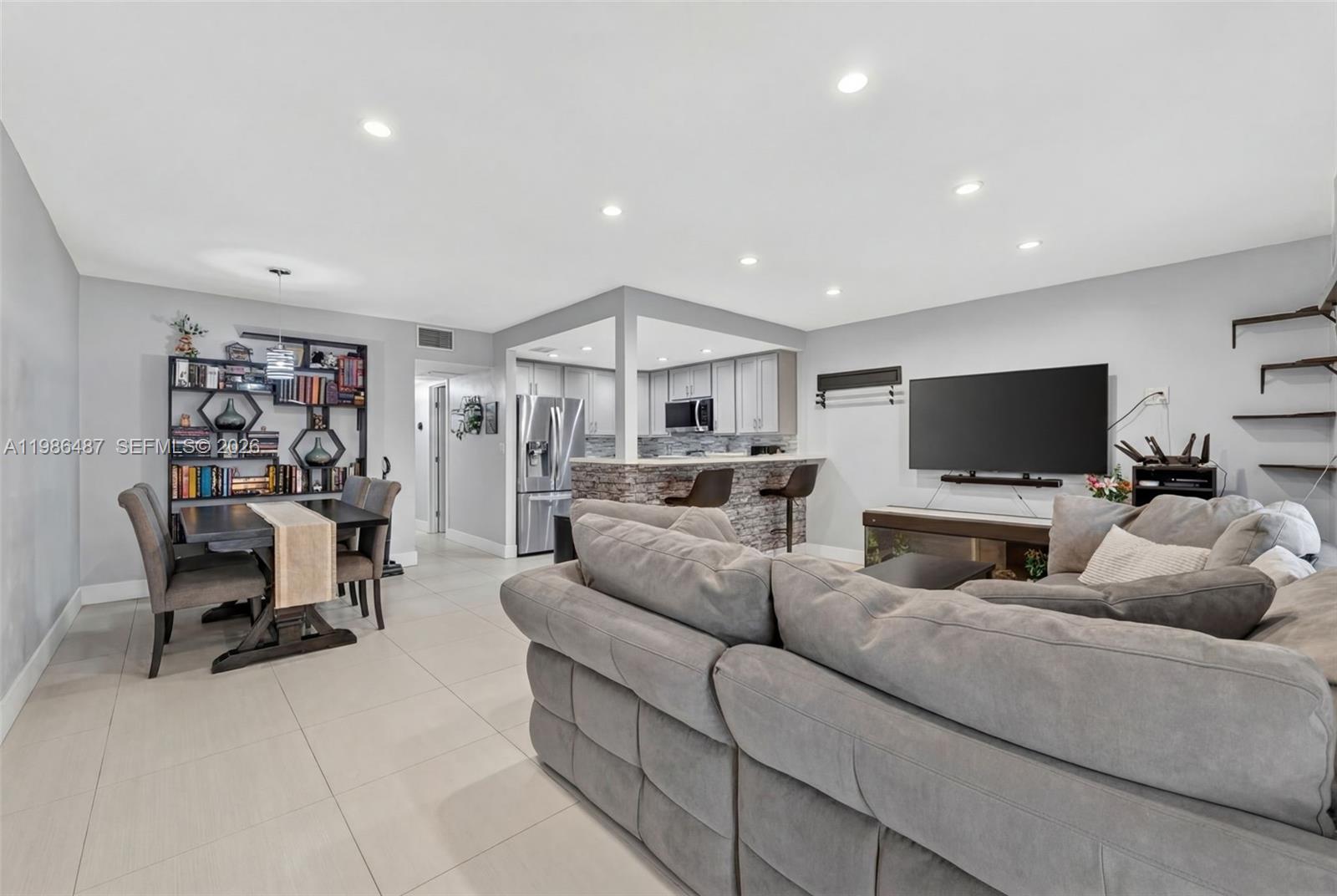 8616 Southwest 103rd Avenue Miami, FL 33173 - Photo 2 of 20 a living room with furniture and a flat screen tv