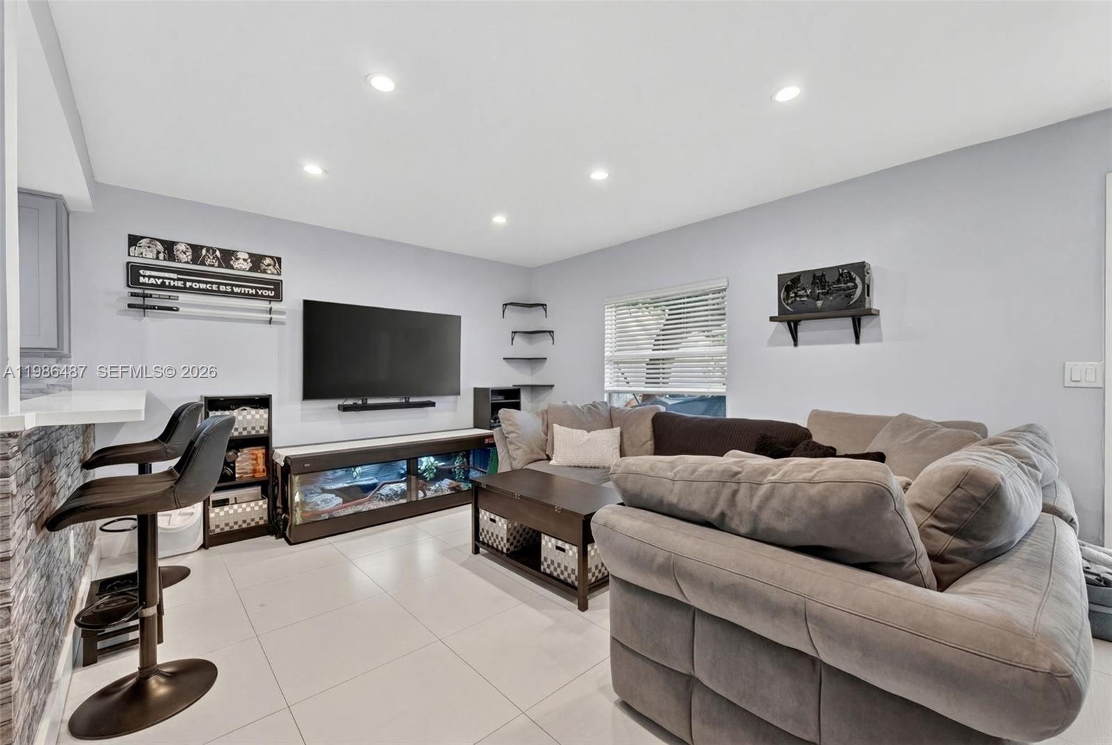8616 Southwest 103rd Avenue Miami, FL 33173 - Photo 4 of 20 a living room with furniture and a flat screen tv