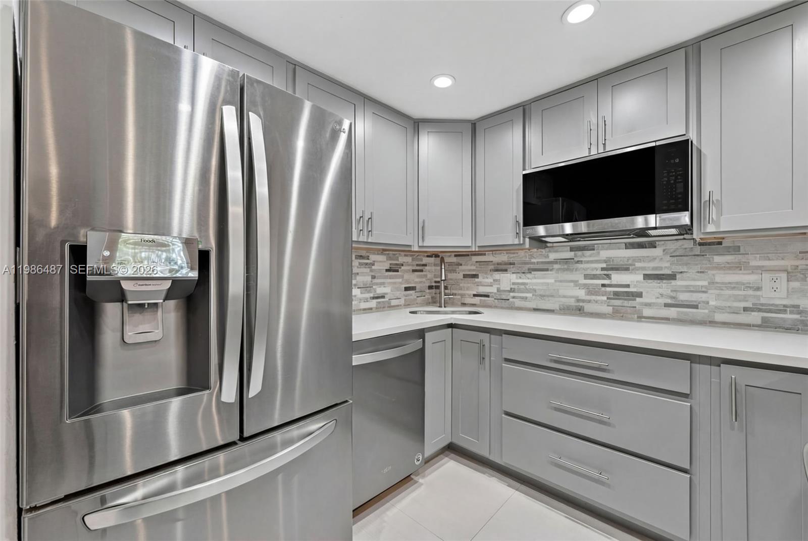8616 Southwest 103rd Avenue Miami, FL 33173 - Photo 6 of 20 a kitchen with stainless steel appliances white cabinets and a refrigerator