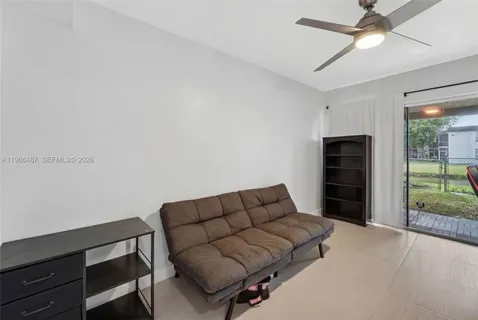 a living room with furniture a air conditioner and a window