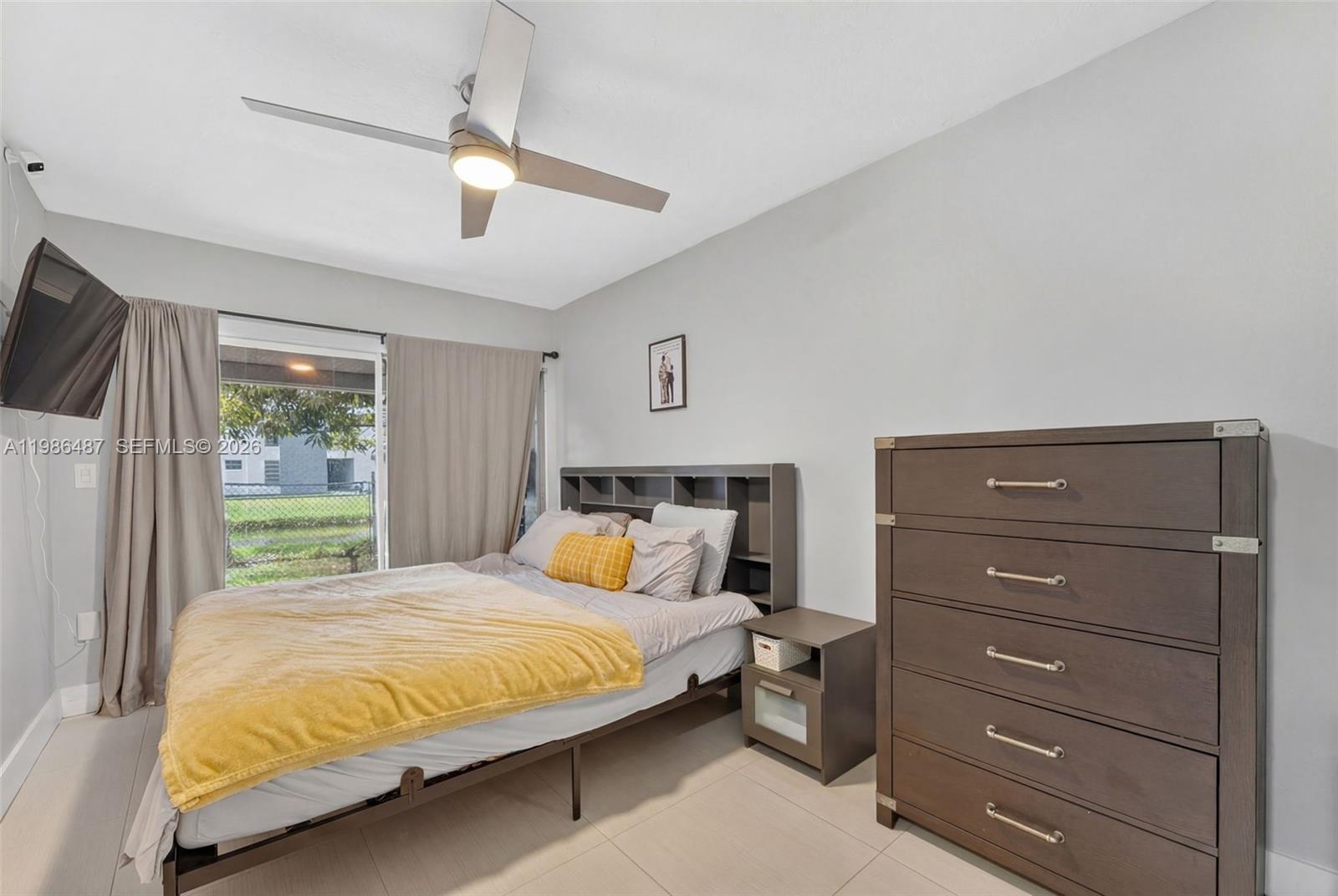 8616 Southwest 103rd Avenue Miami, FL 33173 - Photo 10 of 20 a bedroom with a bed and a television