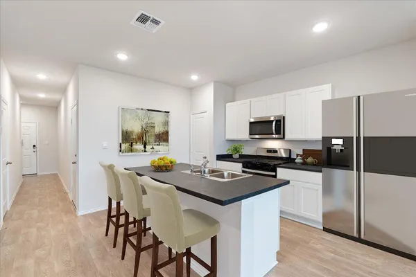 a kitchen with sink stove and cabinets