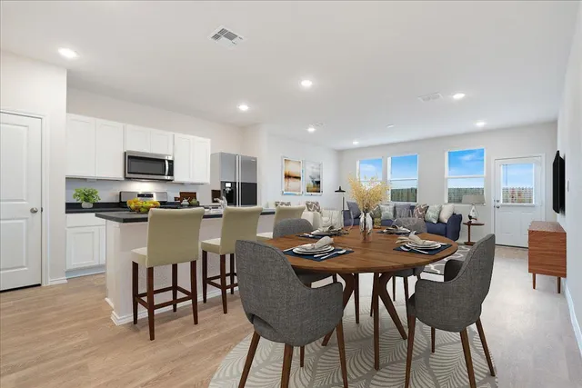 a kitchen that has a table and chairs in it