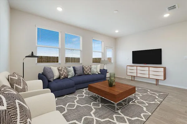 a living room with furniture and kitchen view