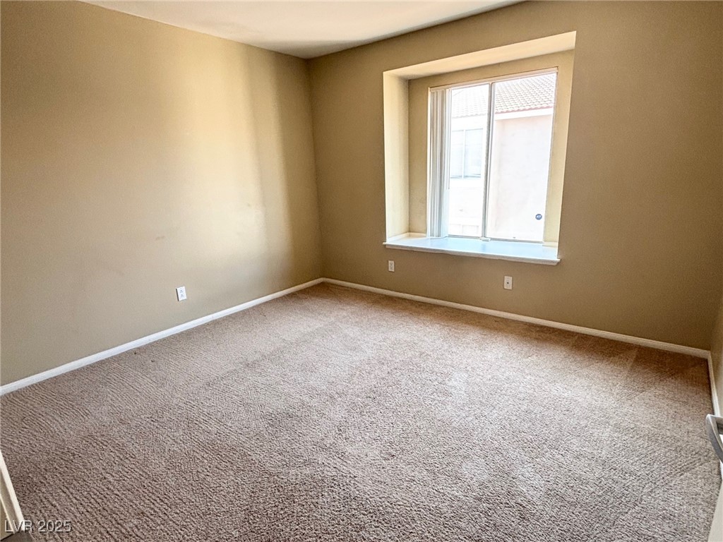 7300 West Pirates Cove Road, Unit 2054 Las Vegas, NV 89145 - Photo 8 of 16 Spare room featuring carpet floors and baseboards