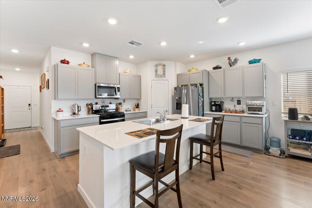 809 Egan Canyon Road Dayton, NV 89403 - Photo 17 of 51 a kitchen with a dining table chairs and wooden floor