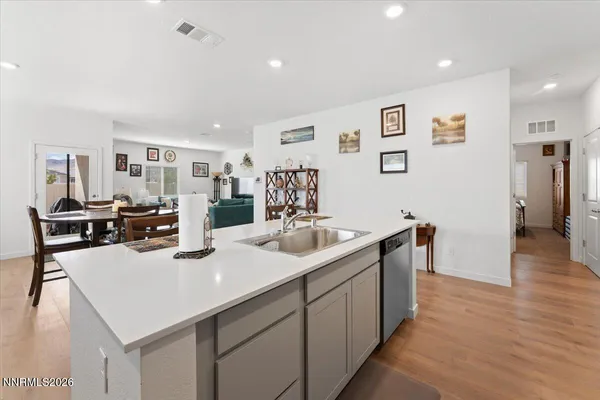 a kitchen with sink refrigerator and cabinets