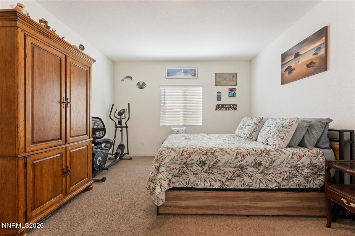 809 Egan Canyon Road Dayton, NV 89403 - Photo 27 of 51 a bedroom with a bed and wooden floor