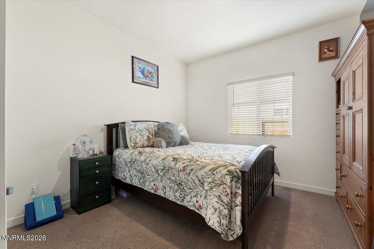 809 Egan Canyon Road Dayton, NV 89403 - Photo 32 of 51 a bedroom with a bed and a window