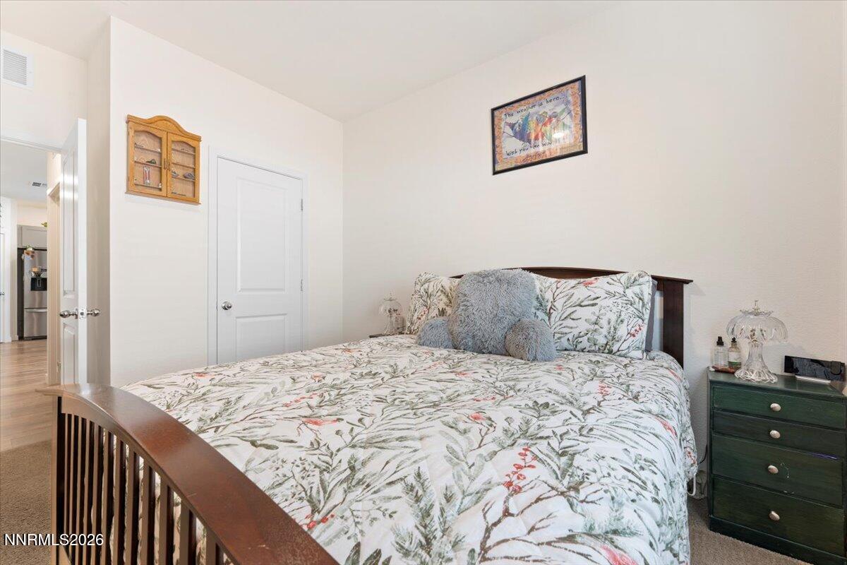 809 Egan Canyon Road Dayton, NV 89403 - Photo 33 of 51 a bedroom with a bed and a painting on the wall