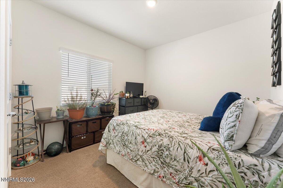 809 Egan Canyon Road Dayton, NV 89403 - Photo 34 of 51 a bedroom with a bed a desk and dresser