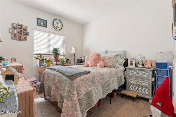 a bedroom with a bed and a table in it