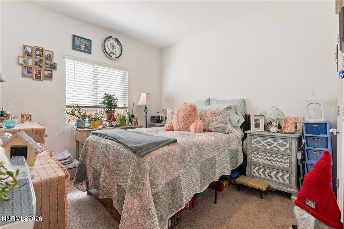 809 Egan Canyon Road Dayton, NV 89403 - Photo 36 of 51 a bedroom with a bed and a table in it