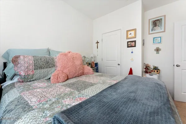 a bedroom with a bed and painting on the wall