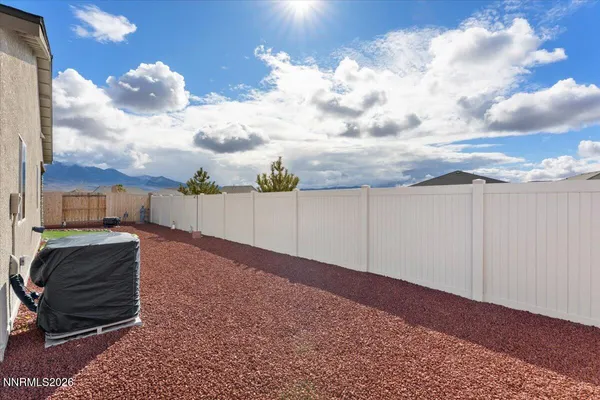 a view of a backyard with sitting area
