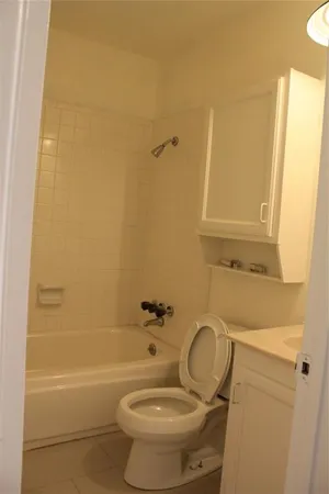 a bathroom with a sink a toilet and bathtub
