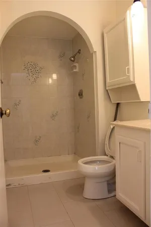 a bathroom with a toilet and a shower
