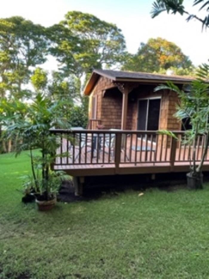 321 West Kuiaha Road Haiku, HI 96708 - Photo 11 of 27 a view of a house with a wooden deck and a yard