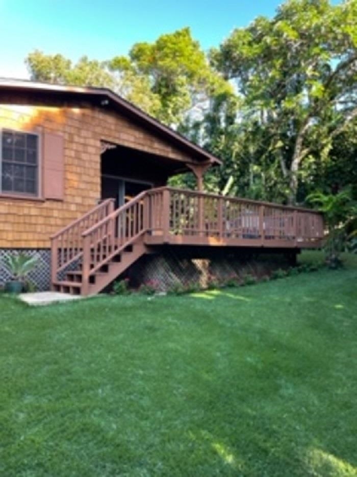 321 West Kuiaha Road Haiku, HI 96708 - Photo 3 of 27 a backyard of a house with wooden floor and fence