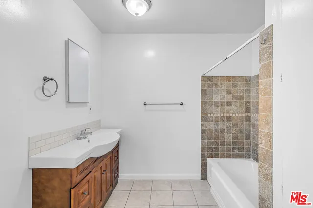 a bathroom with a bathtub and shower