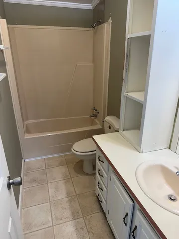 a bathroom with a sink a toilet and a shower
