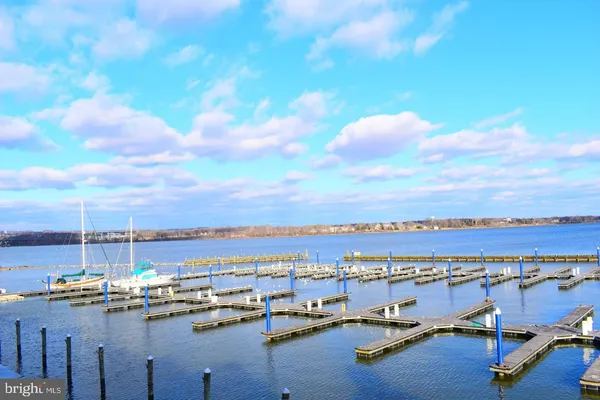 a view of a lake with boats next to a bridge