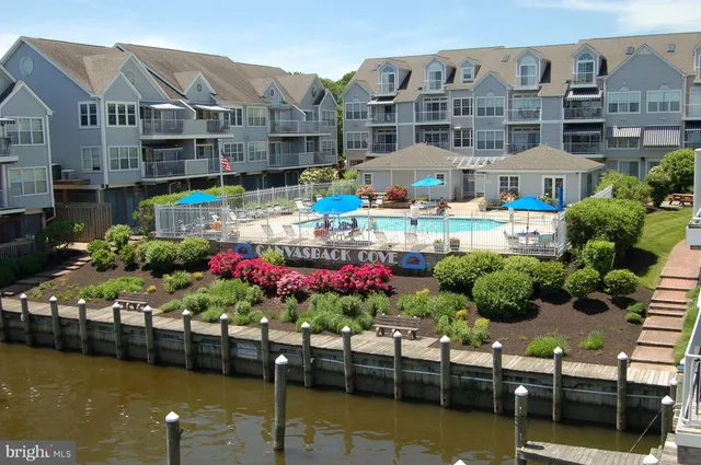a view of a swimming pool with outdoor seating