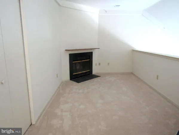 a view of an empty room with a fireplace