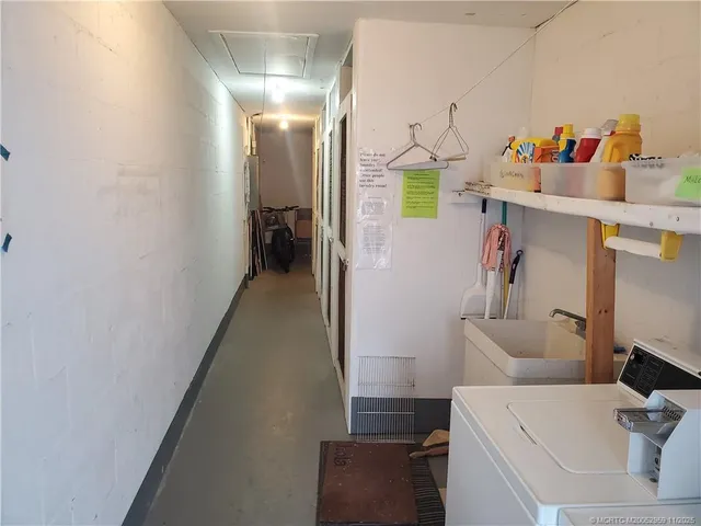 a hallway with table and couch