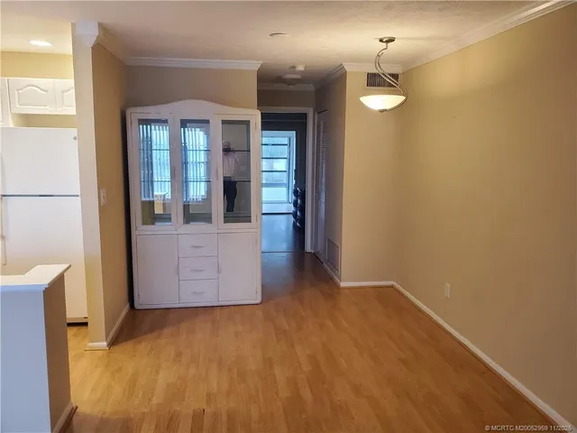 en empty room with a fireplace and mirror