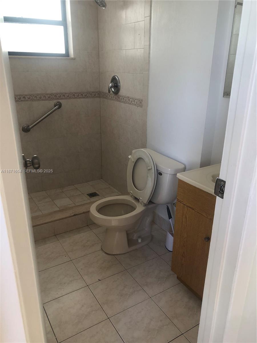 8100 Byron Avenue, Unit 509 Miami Beach, FL 33141 - Photo 11 of 18 a bathroom with a toilet and a shower