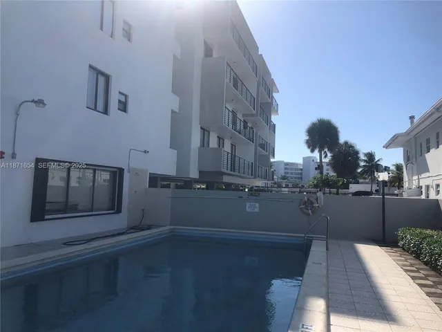 a view of a room with wooden floor and a window