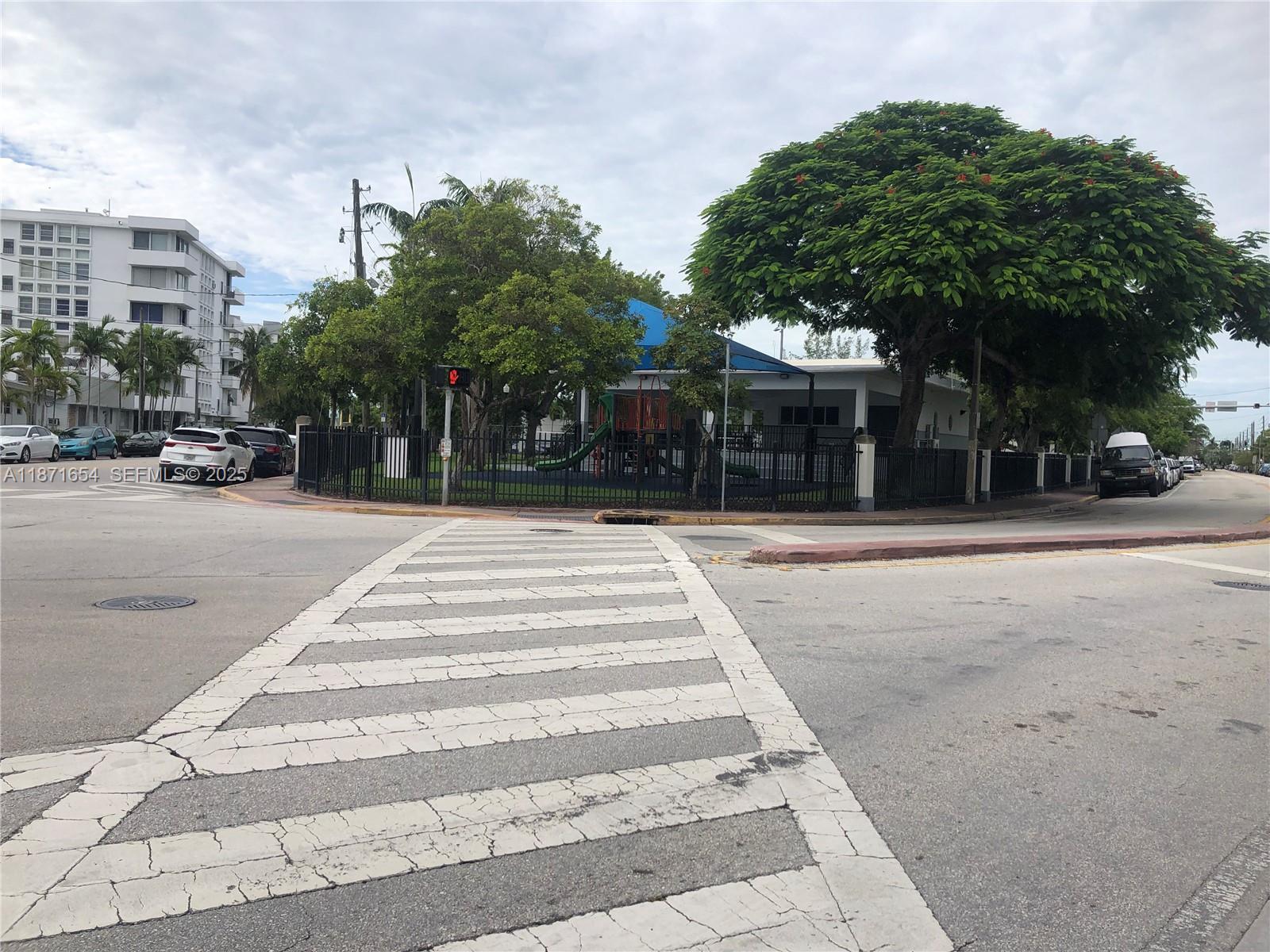 8100 Byron Avenue, Unit 509 Miami Beach, FL 33141 - Photo 16 of 18 a front view of a building with tree s