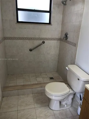a white toilet sitting next to a bathroom sink