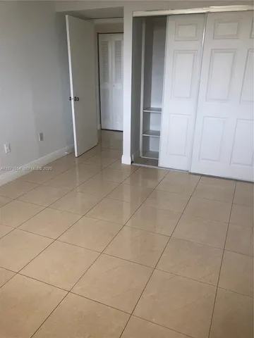 a view of an empty room and entryway