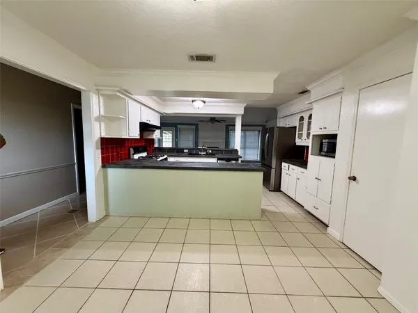 a view of a livingroom with an empty space and a fireplace
