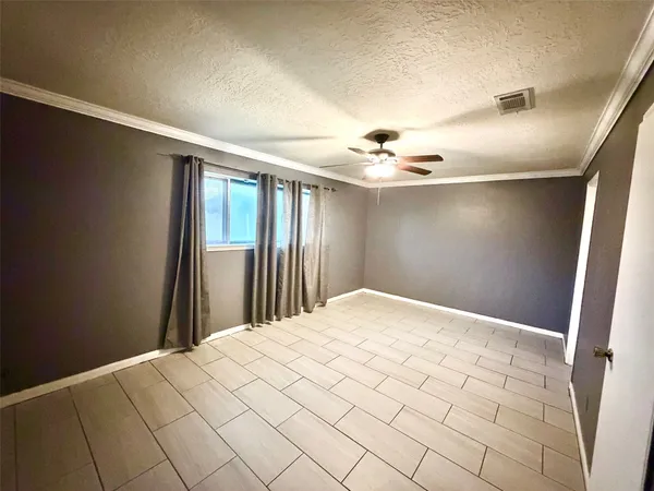 a front view of a house with a garden and tree