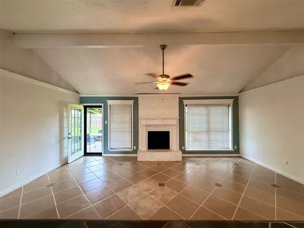 a view of an empty room with a fireplace