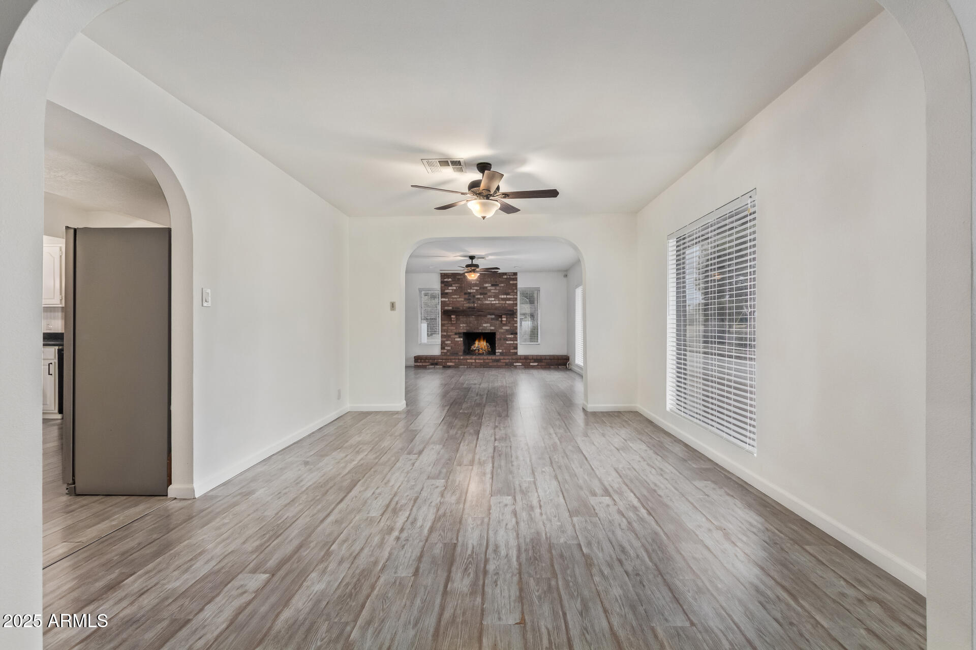 5401 East Exeter Boulevard Phoenix, AZ 85018 - Photo 11 of 47 wooden floor in an empty room with a window