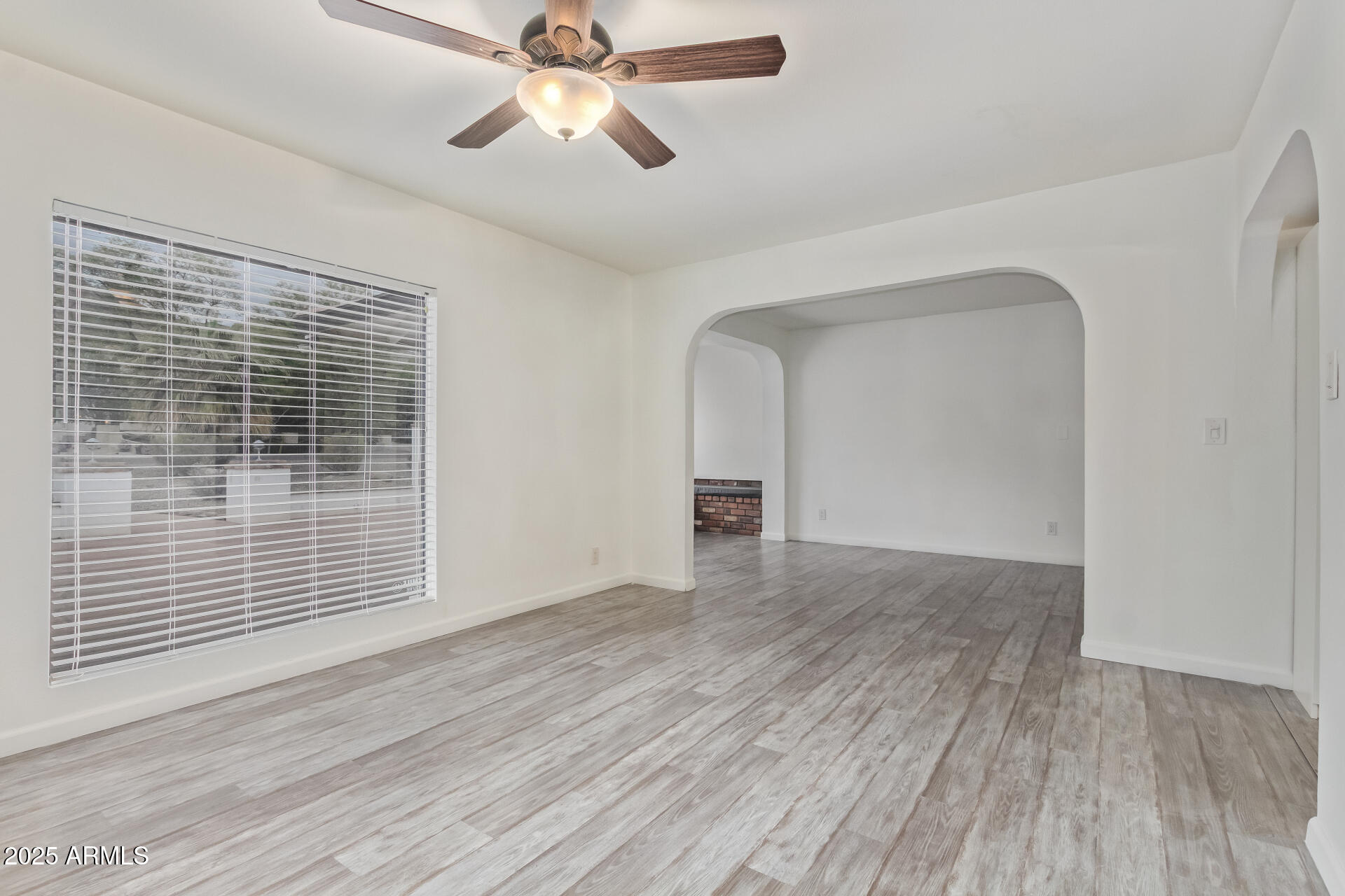 5401 East Exeter Boulevard Phoenix, AZ 85018 - Photo 12 of 47 a view of empty room with wooden floor and fan