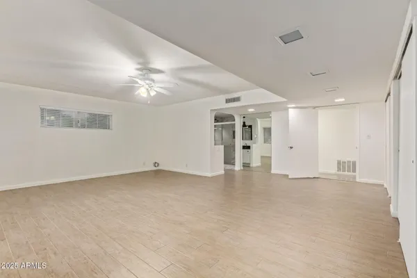 a view of an empty room with a ceiling fan