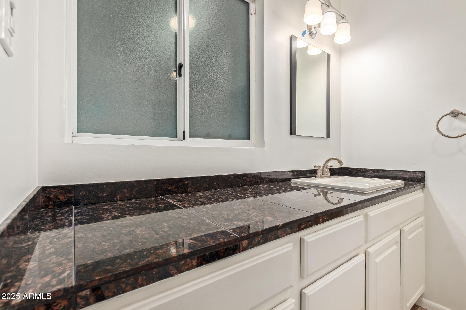 5401 East Exeter Boulevard Phoenix, AZ 85018 - Photo 32 of 47 a bathroom with a granite countertop sink and a mirror