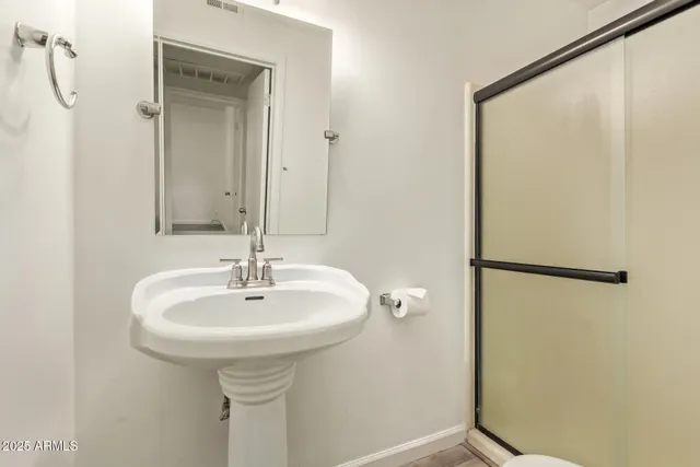 a bathroom with a sink and mirror