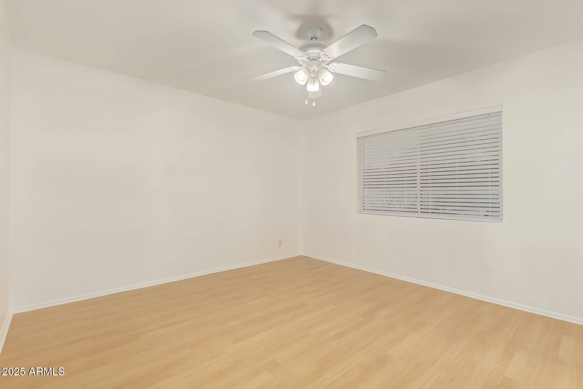 5401 East Exeter Boulevard Phoenix, AZ 85018 - Photo 36 of 47 an empty room with a chandelier fan