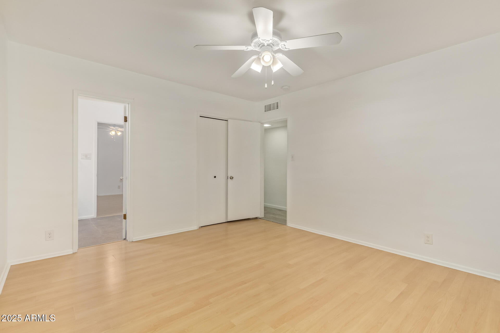 5401 East Exeter Boulevard Phoenix, AZ 85018 - Photo 37 of 47 an empty room with a chandelier fan and closet
