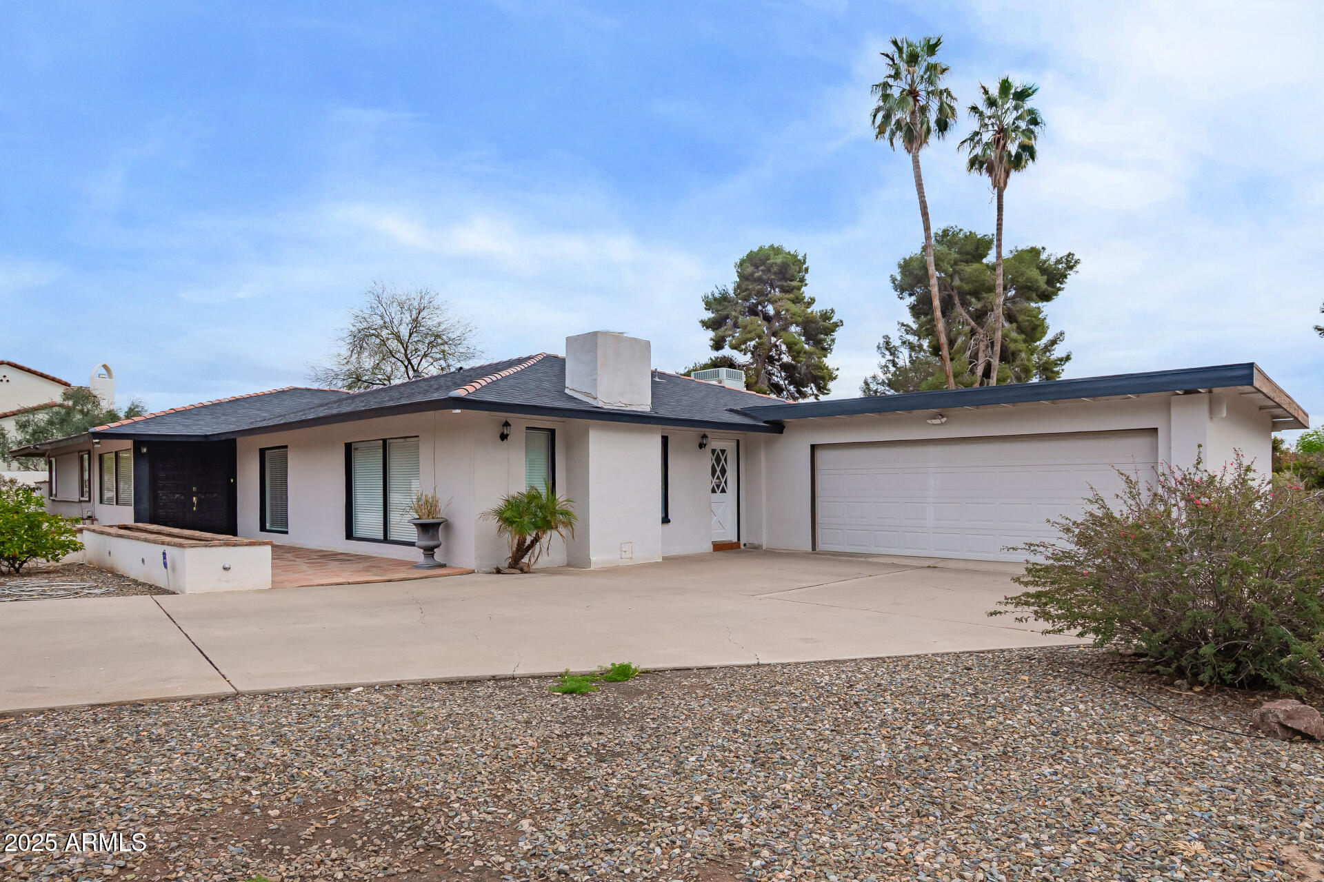5401 East Exeter Boulevard Phoenix, AZ 85018 - Photo 4 of 47 a front view of a house with a yard and garage